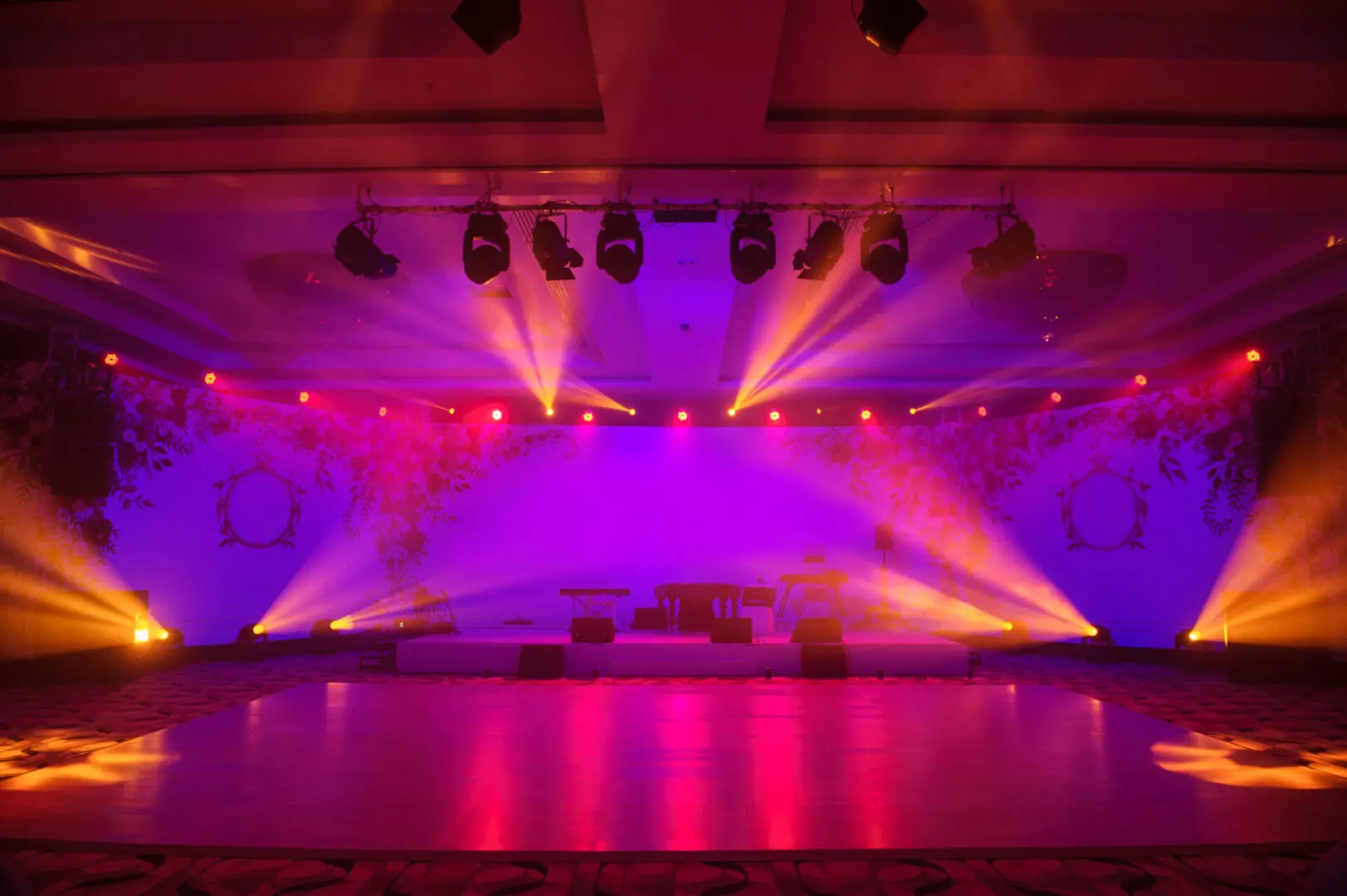 Stage with colorful lighting and empty seats.