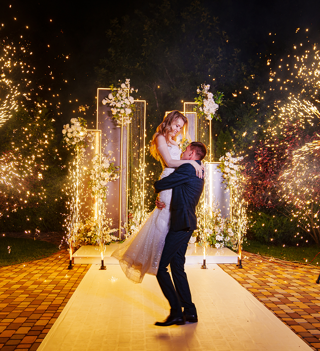 Bride and groom surrounded by wedding sparklers.