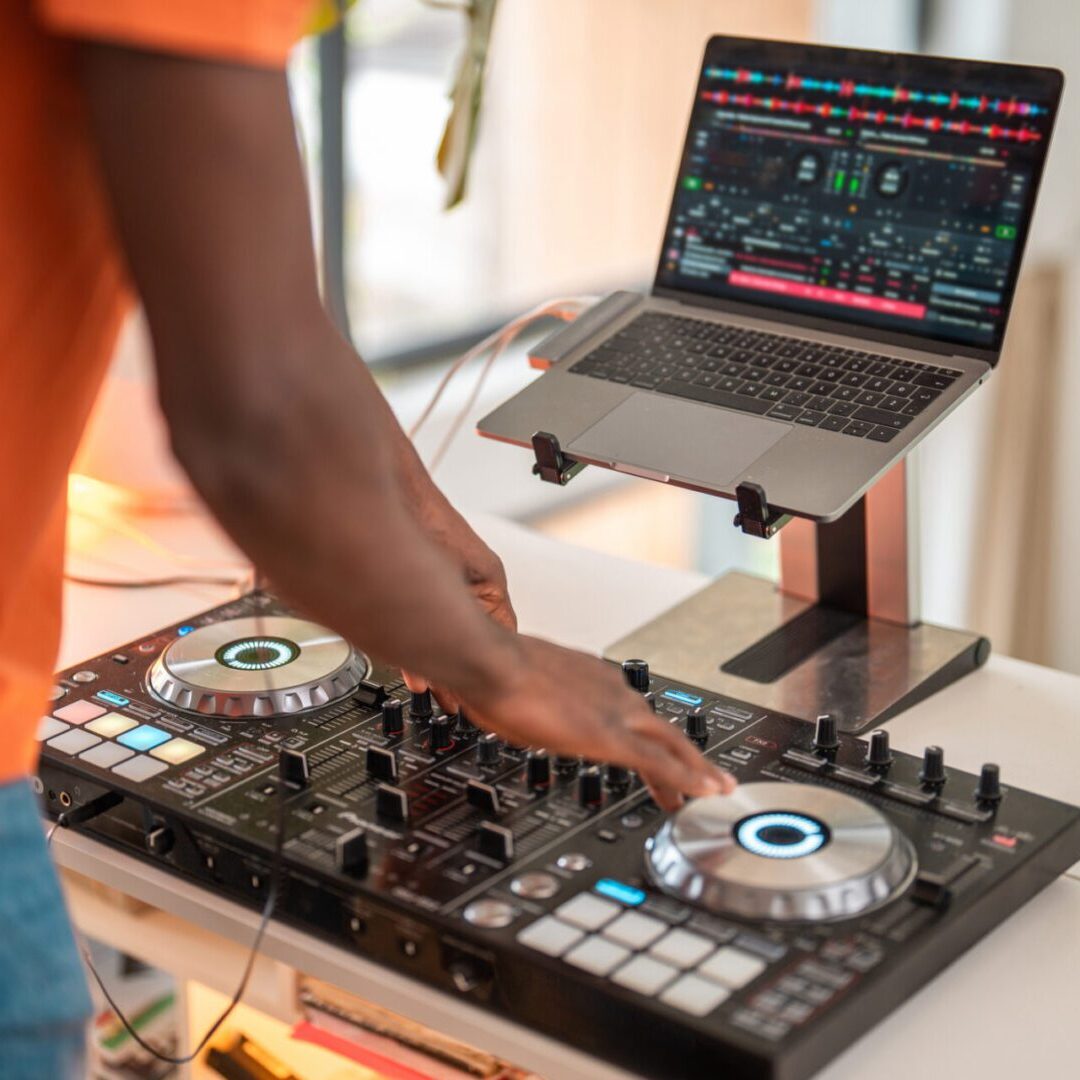 DJ mixing music on a turntable setup.